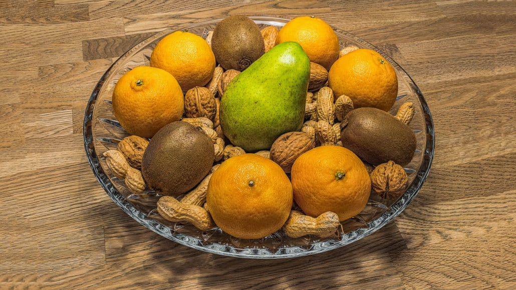Mandarinen, Kiwi und Nüsse in einer Schale